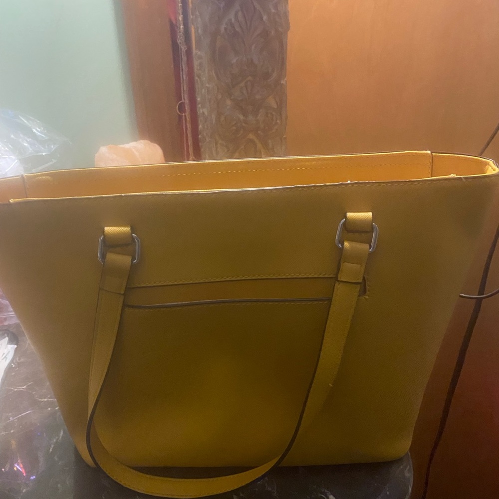 Used Mustard color guess tote bag. Only carried 3-5 times.